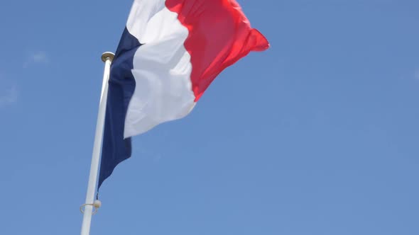 Tricolor French flag against blue sky waving in slow motion 1080p FullHD footage - National flag of 