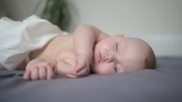 Cute Emotional Newborn Yawning Funny Little Baby Boy Sleeping in Crib