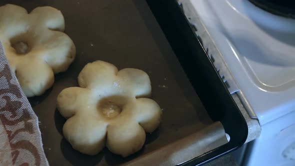 A Woman Covers The Dough Flowers With A Towel. Preparing Donuts In The Form Of A Flower. Close Up. alt