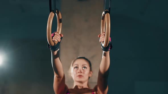 Young Pretty Brunette Pumping Arm and Back Muscles. Sexy Girl Holds Weight, Strains Biceps alt