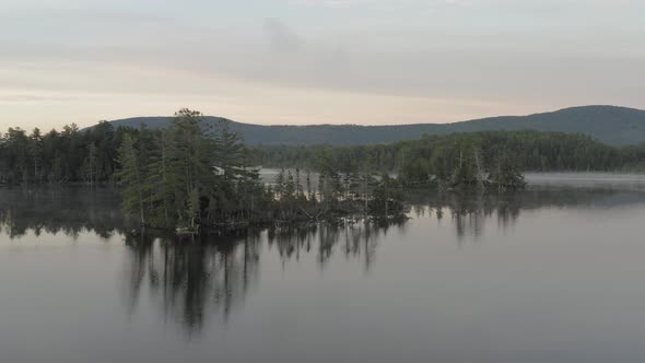Prong Pond island wilderness aerial sunrise pull back alt