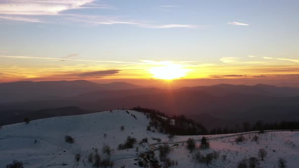 Aerial view at the mountain on a sunset of the winter day