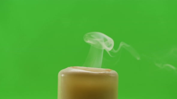 Burning Wax Candle on Green Chroma Key Background alt
