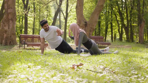 Happy Active Man and Woman Giving High Five to Each Other While Standing in alt