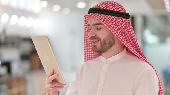 Portrait of Arab Businessman Doing Video Call on Digital Tablet alt