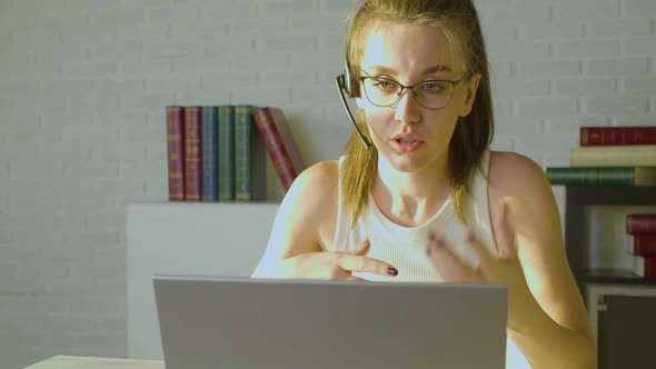Closeup View of a Young Adult Woman Works in Front of a Laptop Monitor  She Having Online Video Call alt