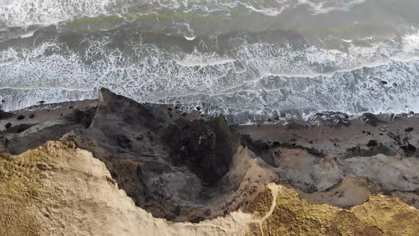 Aerial view of the steep slopes and waves at Rubjerg Knude by the North Sea, Denmark alt