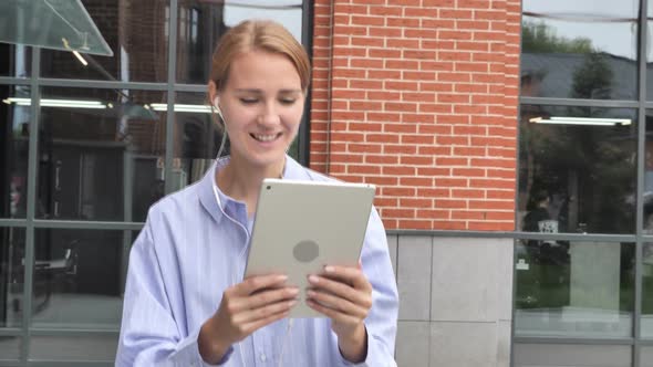 Online Video Chat on Tablet By Walking Woman on Street alt