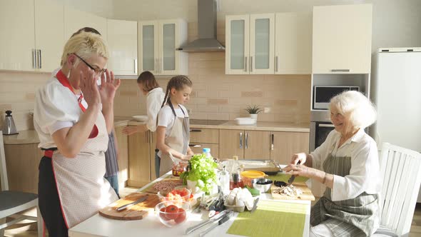 Positive Diverse Generation Family Women Chopping Ingredients for Pizza Cooking