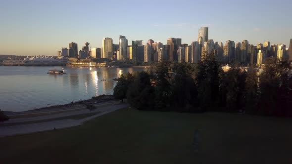 Downtown Skyline Of Coal Harbour Seen From Brockton Point At Stanley Park During Sunrise Surrounded alt