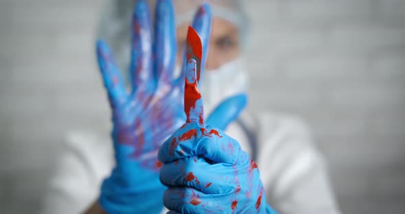 Steel scalpel in blood. alt