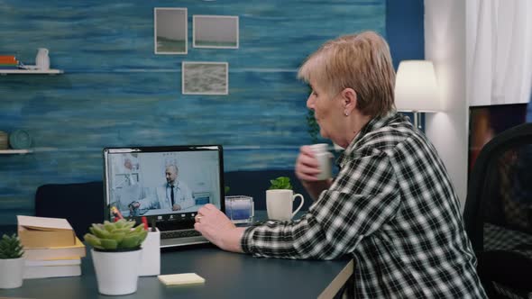 Lady Writing Notes During Online Medical Consultation Listening alt