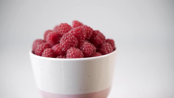 Fresh Juicy Ripe Raspberries in White Cup