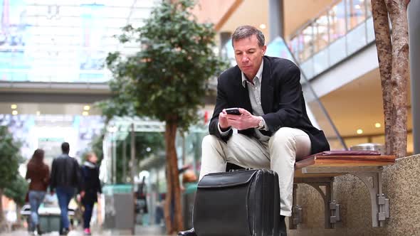 Businessman using smart phone in the city