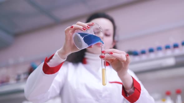 Scientist Mixes Liquids in Lab