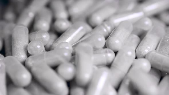 Close Up of Capsule Pills Moving with Time Intervals alt