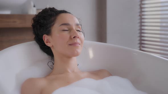 Closeup Young Attractive Relaxed Woman Lying in Hot Foam Bath with Eyes Closed Resting Relaxing in alt