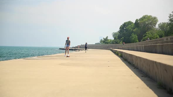 A young woman goes longboard skateboarding. alt