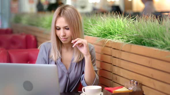 Medium Shot Portrait of Pretty Smiling Businesswoman Working at Cafe Using Laptop alt