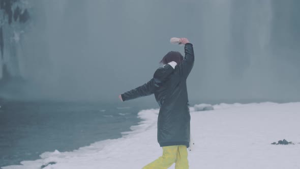 Happy Young Woman Have Fun Near Skogafoss Waterfall in Iceland alt