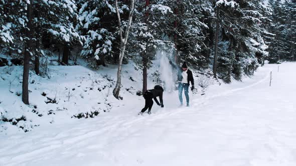 Young Happy Couple Playing on the Snow alt