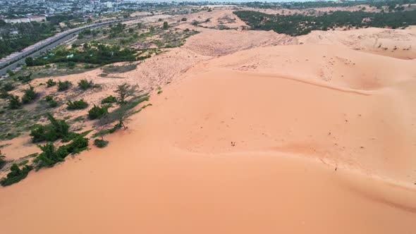 aerial circling a red desert sand dune along the coast of Mui Ne Vietnam alt