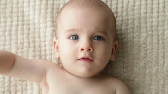 Baby Boy Lying on Blanket, from Above alt