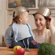 Happy Laughing Mother with Baby Son Playing on Kitchen with Cooking Pans on Heads - VideoHive Item for Sale
