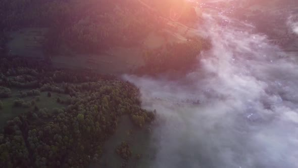 Aerial Drone View of Fog Inversion Clouds in a Rural Valley Above the Village in Forest Landscape