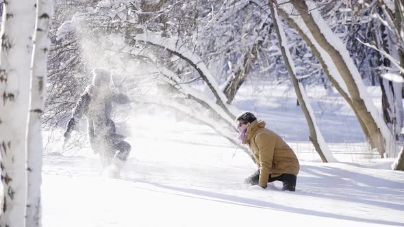 Happy Romantic Couple Playing with Snow at Sunny Winter Day alt