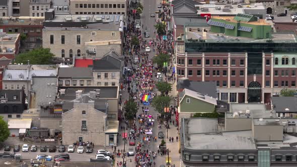 City Aerial shot of People celebrating Pride Day with a Parade alt
