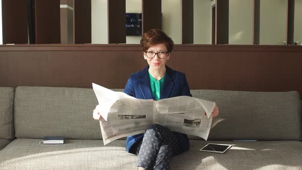 Gorgeous Girl Is Reading the News in the Modern Room