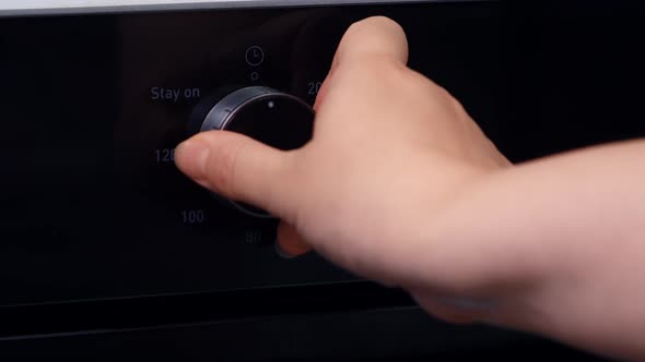 Woman Sets Cooking Time Oven alt
