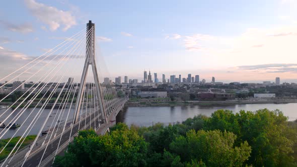 Aerial View of the Cable Bridge in the Sunset with City on the Background