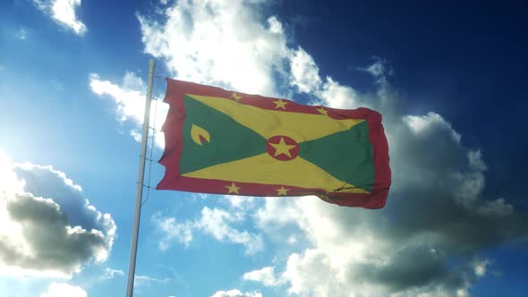 Flag of Grenada Waving at Wind Against Beautiful Blue Sky alt