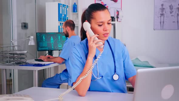 Assistant Discussing at Phone with Patient About Diagnosi alt