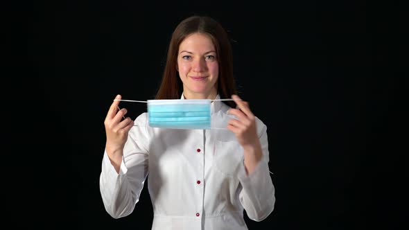 A Nurse Shows How To Wear Mask Correctly. Social Distancing Rules. Healthcare and Pandemic Time.