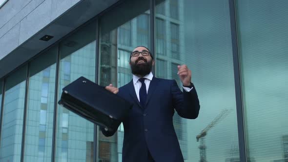 Extremely Happy Man in Suit Raising Hands in Winner Gesture, Profitable Business