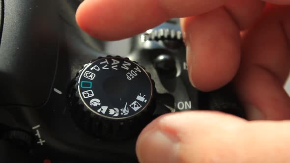 Turning The Settings Wheel On Photo Camera