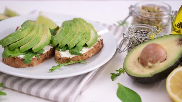 Healthy Breakfast or Snack  Soft Cheese and Avocado Sandwich on a Plate alt