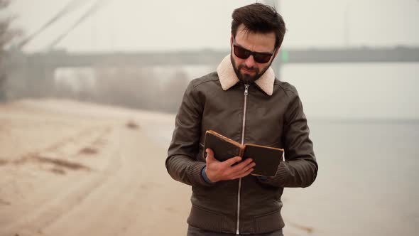 Man Walking On Beach And Reading Book. Businessman Take Break Relax After Hard Work In Office. alt