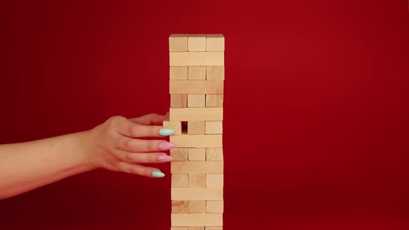 Jenga Game on Red Background alt