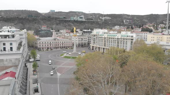 Flying over column of freedom in the center of Tbilisi, St, George monument alt
