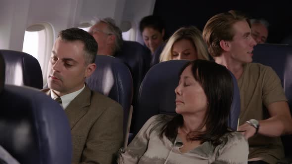Woman trying to sleep on airplane flight
