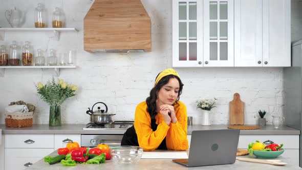 Thoughtful Woman Study Online Video Call Webcam Laptop Webinar Course in Kitchen alt