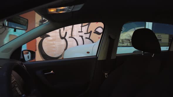 Woman Put a Jacket on the Car Seat and Sits Down on the Driver's Seat Intending To Start the Engine alt