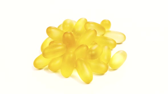 Organic supplements vitamins yellow capsules Omega 3 or D-3 on white background alt