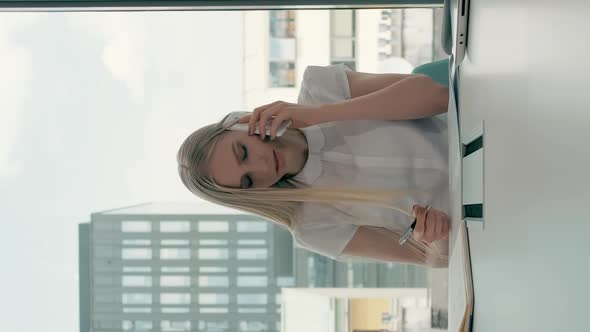 Serious Woman Working in Light Office Room, Elegant Modern Businesswoman with Laptop and Papers  alt