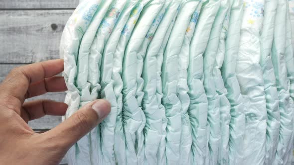 Stack of Baby Diaper on Table alt