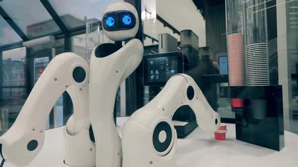 Futuristic Robot, Innovative Technology Concept. Droid Is Taking a Paper Cup and Moving It To a alt